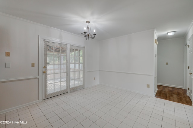 tiled spare room with a notable chandelier and crown molding