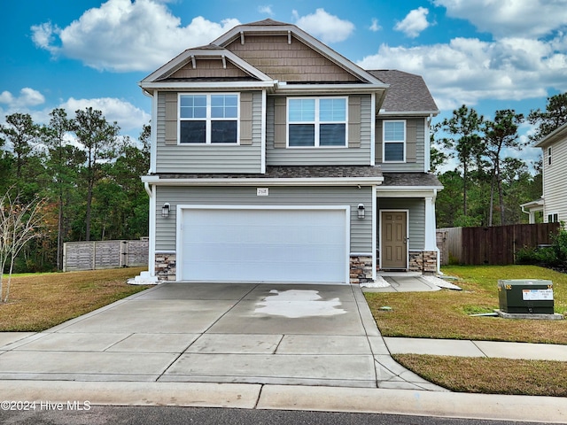 craftsman inspired home featuring a front yard and a garage