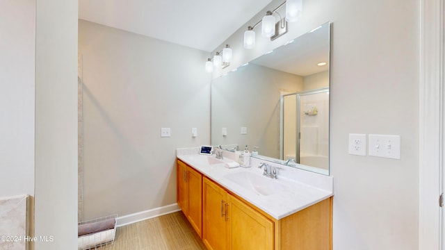 bathroom with vanity and a shower with shower door