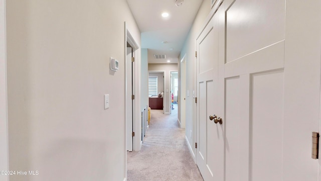 hallway with light colored carpet