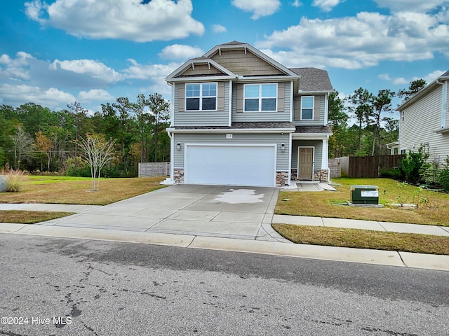 craftsman-style home with a garage and a front yard