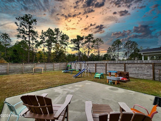 patio terrace at dusk with a lawn and a playground