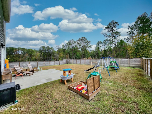 view of play area featuring a patio area and a yard