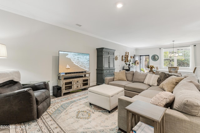 living room featuring a chandelier and crown molding