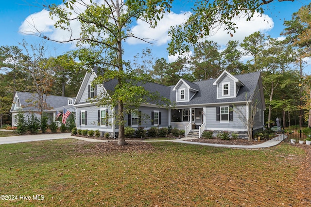 cape cod-style house featuring a porch and a front yard