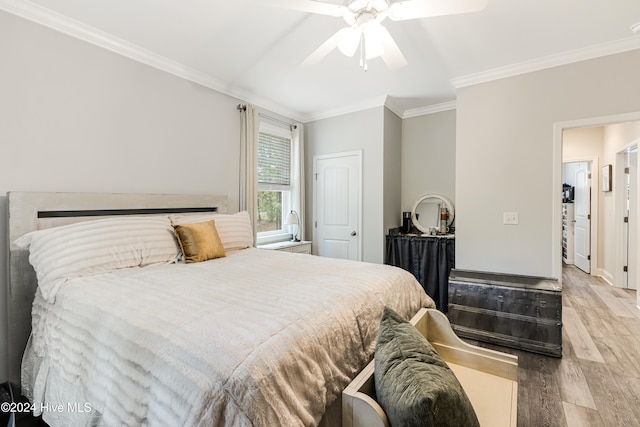 bedroom with hardwood / wood-style flooring, ornamental molding, and ceiling fan