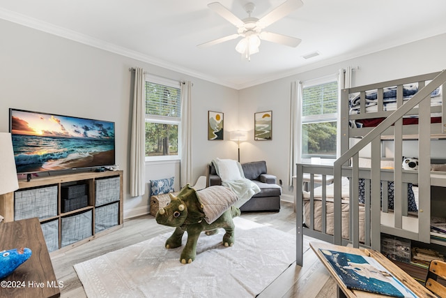 interior space with light hardwood / wood-style floors, ceiling fan, and ornamental molding