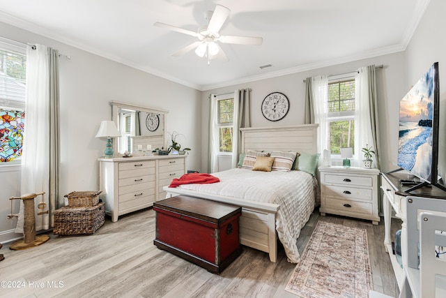 bedroom featuring crown molding, ceiling fan, and light hardwood / wood-style flooring