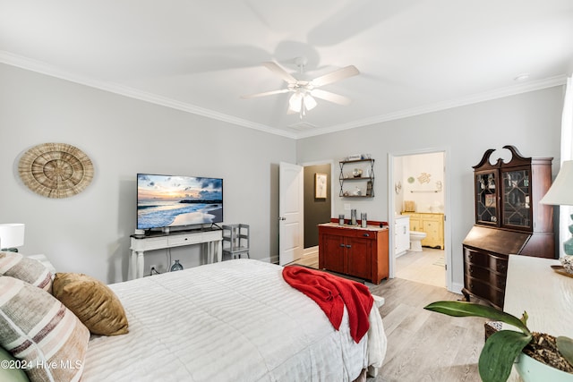 bedroom with ceiling fan, ornamental molding, light wood-type flooring, and connected bathroom