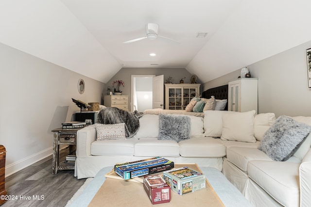 living room with hardwood / wood-style flooring, ceiling fan, and vaulted ceiling