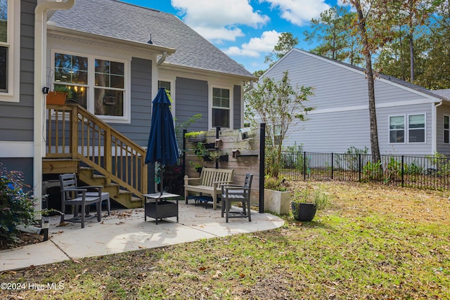 rear view of house with a patio area, an outdoor fire pit, and a yard