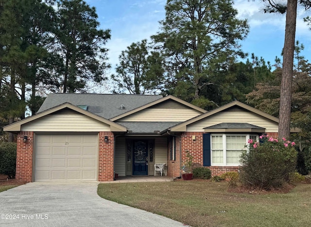 ranch-style home featuring a garage and a front lawn