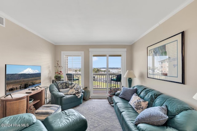 carpeted living room with ornamental molding