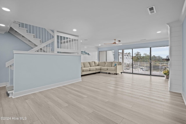 unfurnished living room with baseboards, light wood-style flooring, ceiling fan, stairway, and recessed lighting