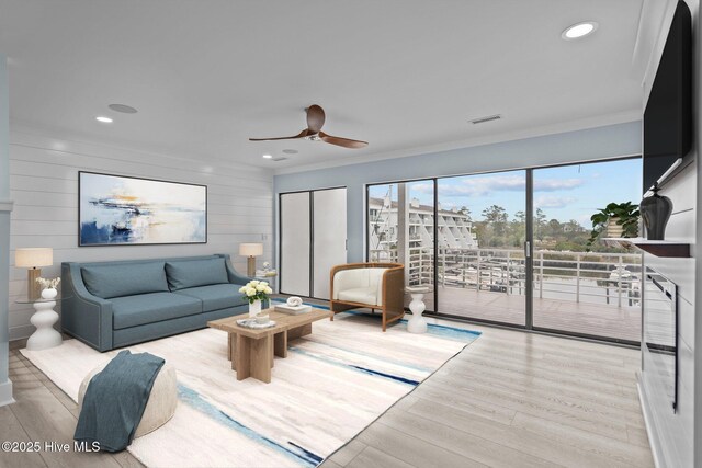 unfurnished living room featuring ceiling fan and light wood-type flooring