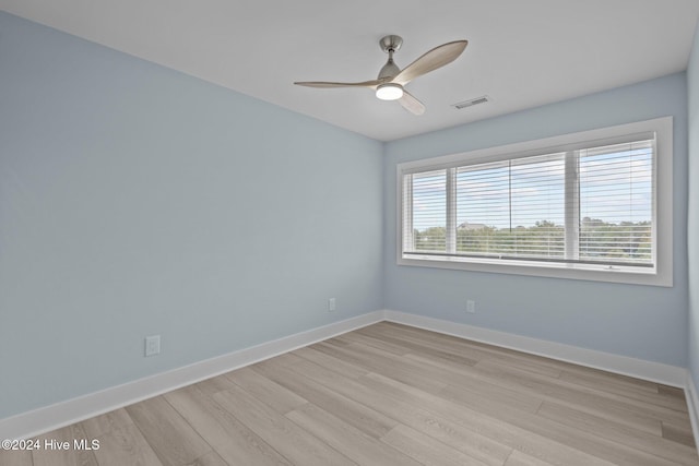 unfurnished room with a ceiling fan, baseboards, visible vents, and light wood finished floors