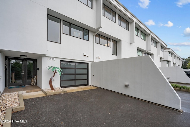 view of property featuring a garage and driveway