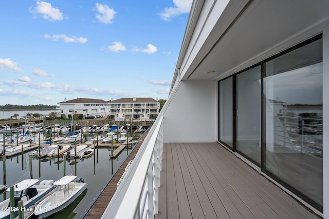 balcony with a boat dock and a water view