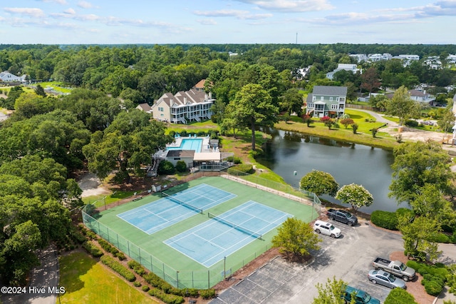 drone / aerial view with a water view and a wooded view