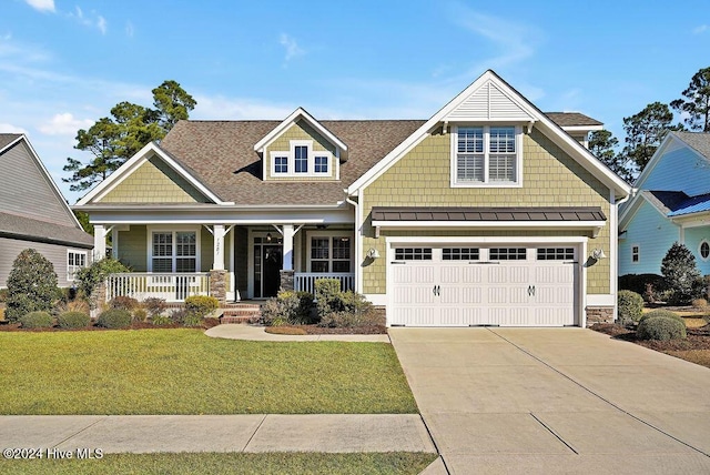 craftsman house featuring a front yard, a porch, and a garage