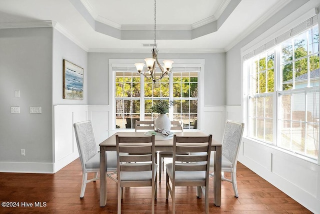 dining space with crown molding, plenty of natural light, and dark wood-type flooring