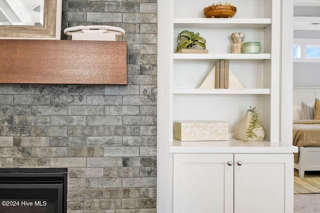 bar with white cabinetry, hardwood / wood-style floors, and built in features