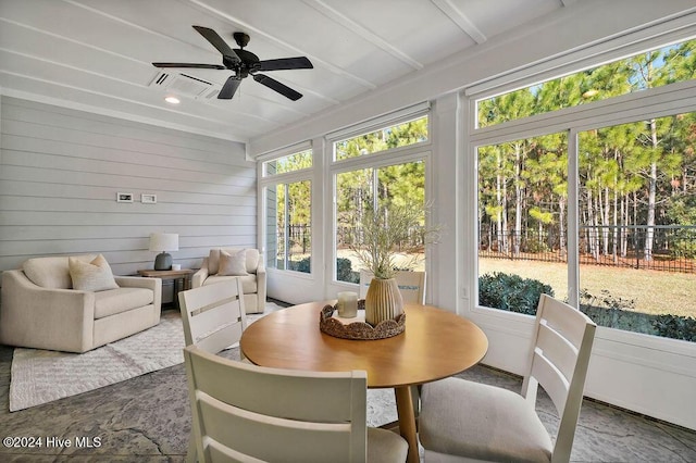 sunroom / solarium featuring a wealth of natural light and ceiling fan