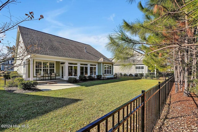 back of house featuring a patio area and a yard