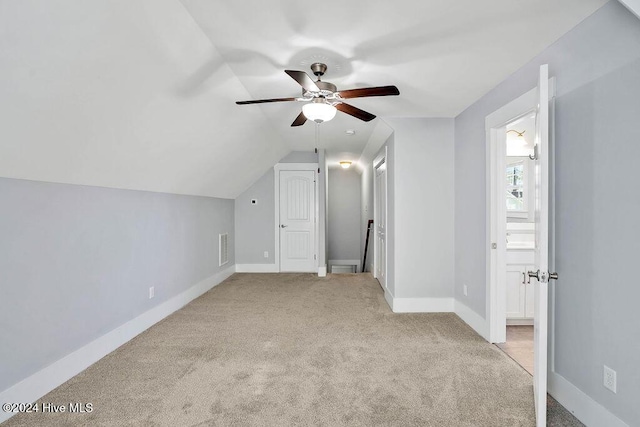 bonus room featuring ceiling fan, light colored carpet, and vaulted ceiling