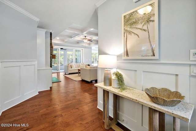 corridor with beam ceiling, crown molding, dark wood-type flooring, and coffered ceiling