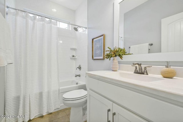 full bathroom featuring tile patterned flooring, vanity, toilet, and shower / bath combo with shower curtain