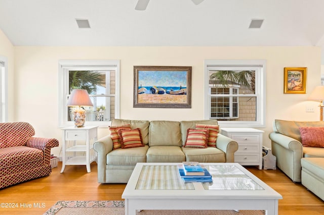 living room with light wood-type flooring and ceiling fan