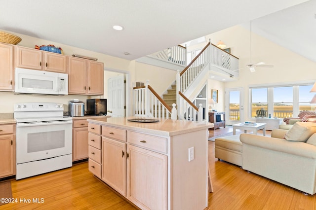 kitchen featuring light brown cabinets, ceiling fan, high vaulted ceiling, white appliances, and light hardwood / wood-style flooring