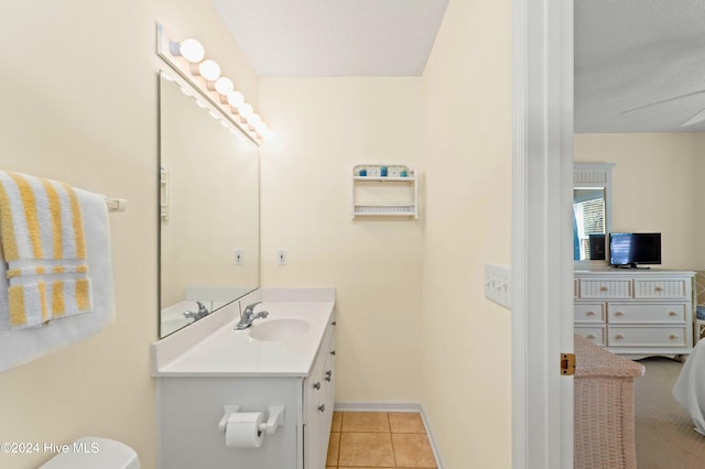 bathroom featuring toilet, vanity, and tile patterned floors