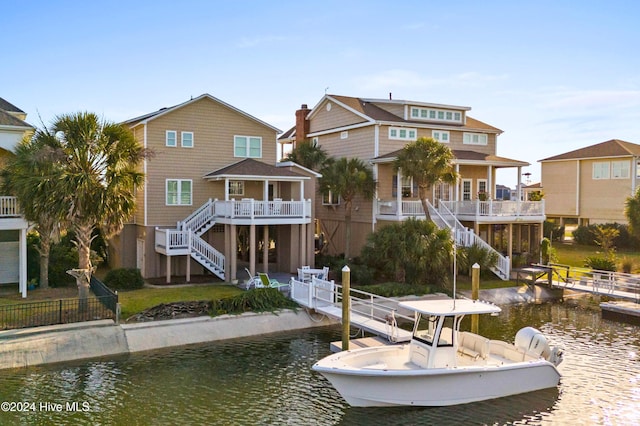 back of house with a deck with water view