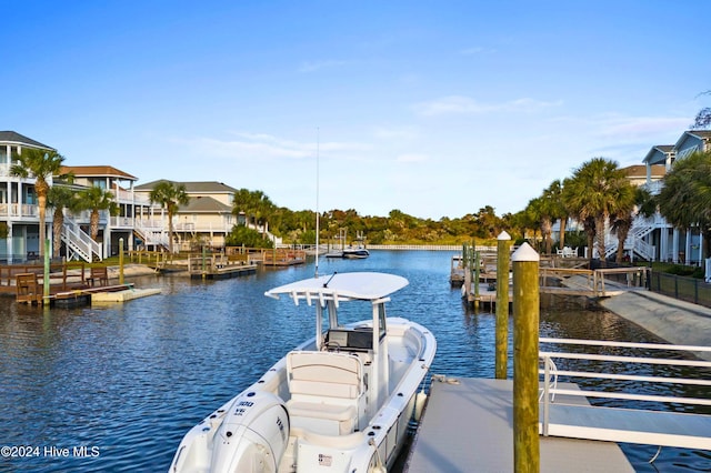 wooden deck featuring a dock and a water view