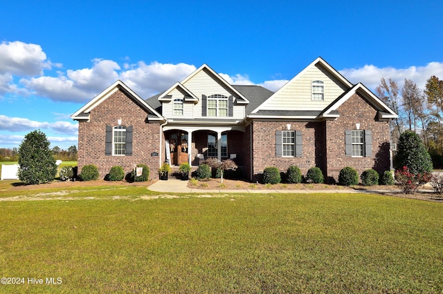 craftsman-style house featuring a porch and a front lawn