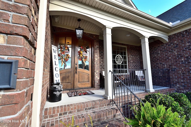 view of exterior entry with covered porch