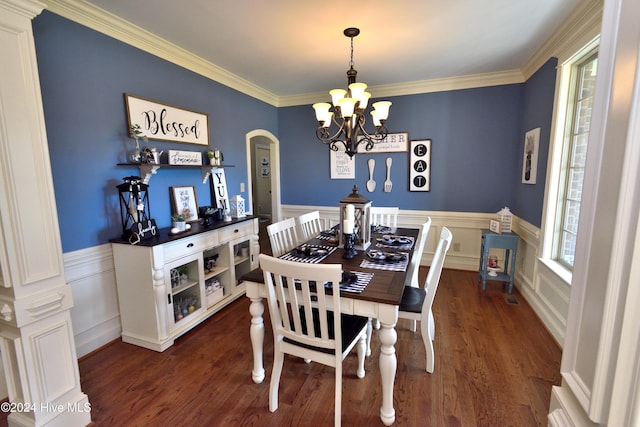 dining room with dark hardwood / wood-style flooring, ornamental molding, and a chandelier