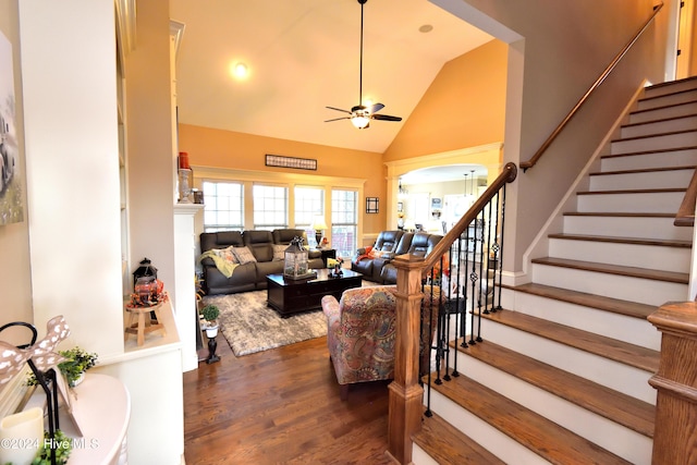 staircase featuring hardwood / wood-style flooring, ceiling fan, high vaulted ceiling, and decorative columns