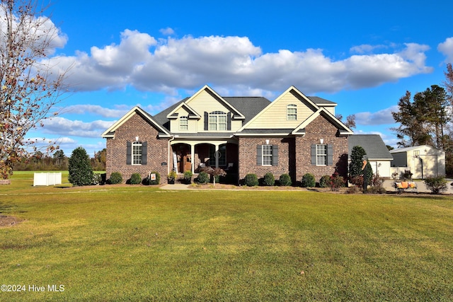 view of front of house featuring a front yard and covered porch