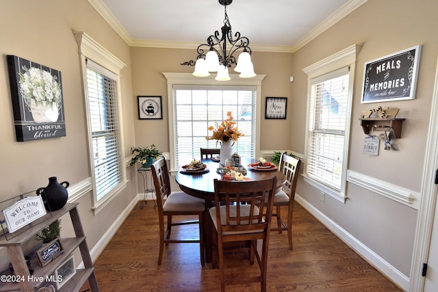 dining space featuring dark hardwood / wood-style flooring, a notable chandelier, and crown molding