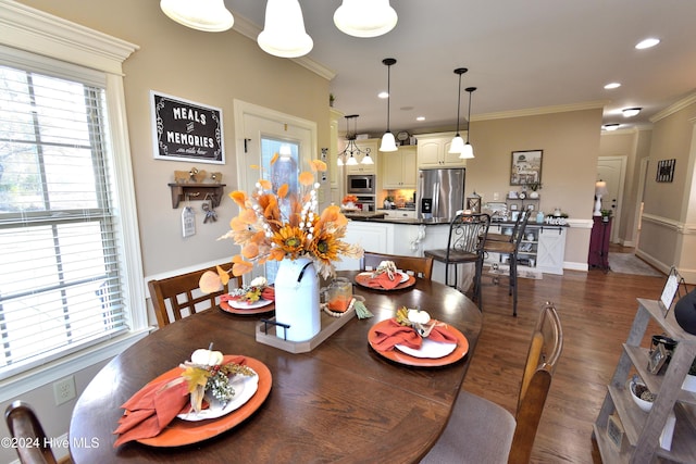 dining area with crown molding, dark wood-type flooring, and a wealth of natural light