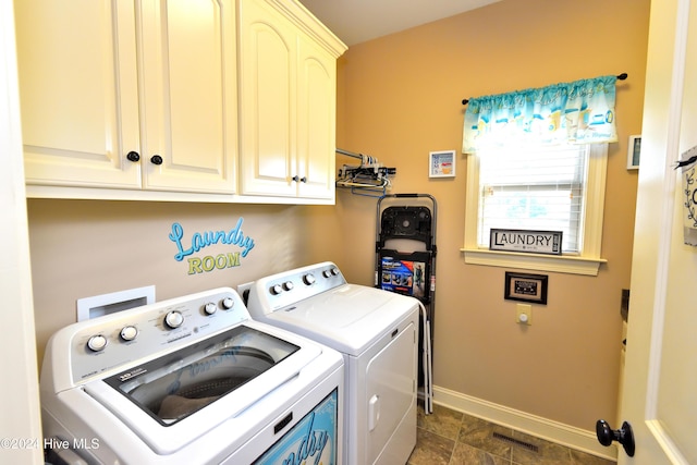 laundry room with cabinets and washing machine and dryer