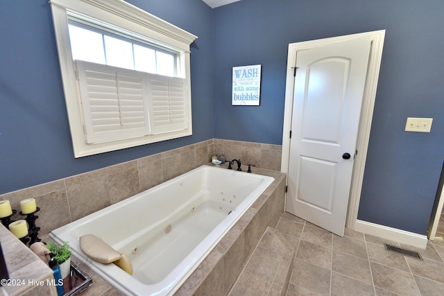 bathroom featuring tiled bath and tile patterned flooring