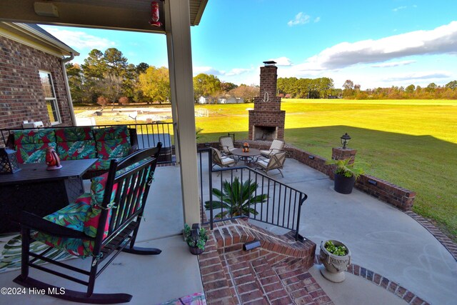 view of patio / terrace with an outdoor brick fireplace