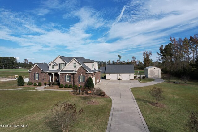 view of front of house with a garage, a shed, and a front yard