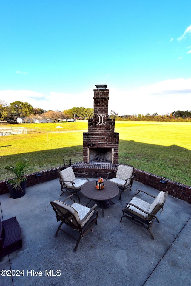 view of patio featuring an outdoor brick fireplace