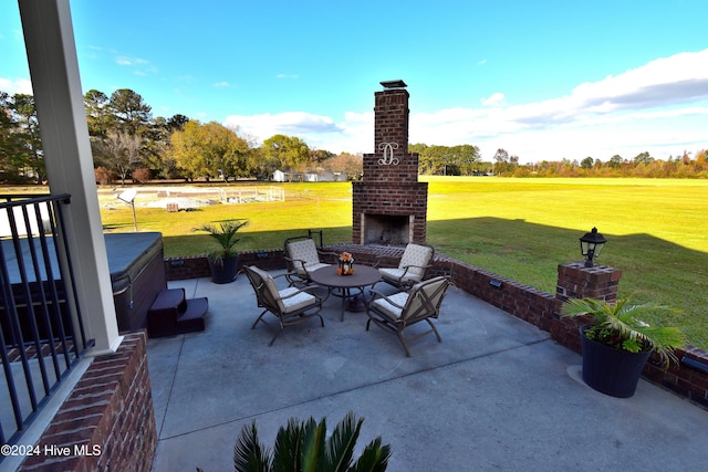 view of patio / terrace featuring an outdoor brick fireplace and a hot tub