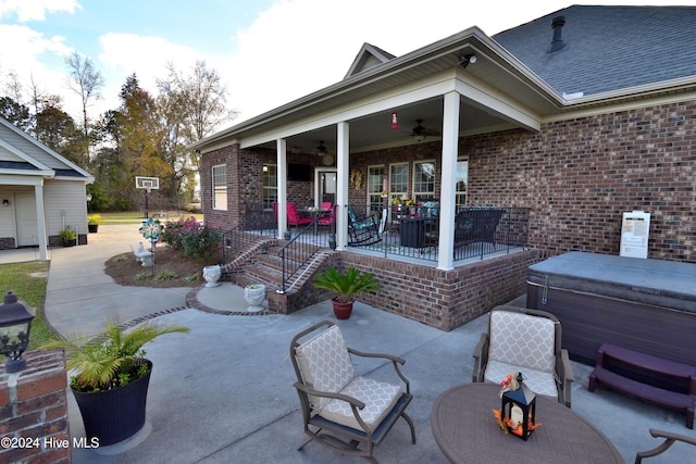 view of patio featuring a hot tub and ceiling fan